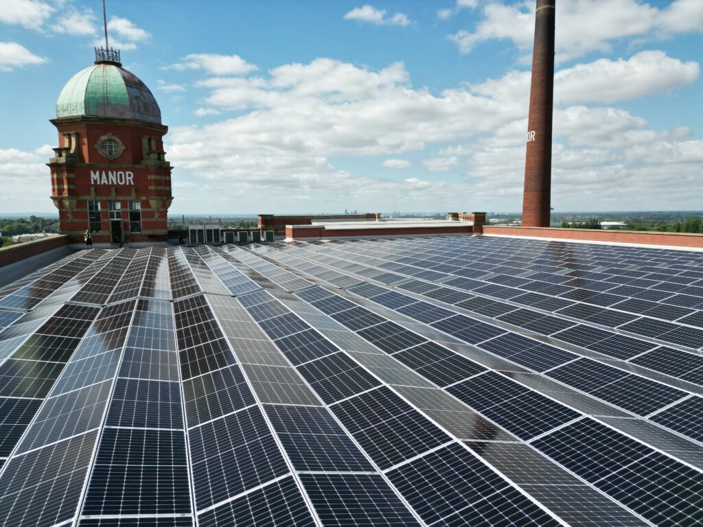 Aerial photograph of solar panel installation on the roof of Manor Mill in Oldham.