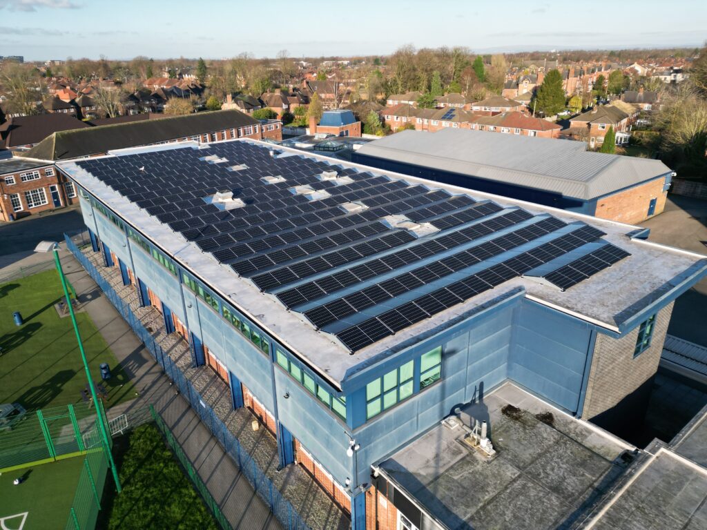 Aerial photograph of a commercial solar panel installation.